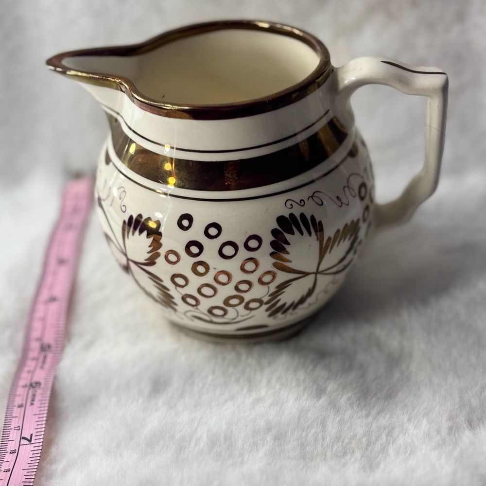 Gold and White Ceramic Pitcher with Floral Art